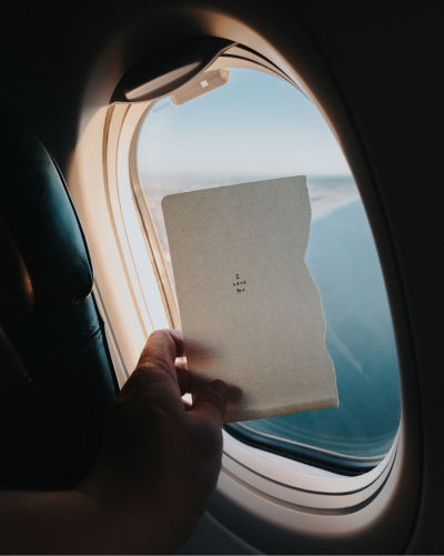 Letter held up against airplane window